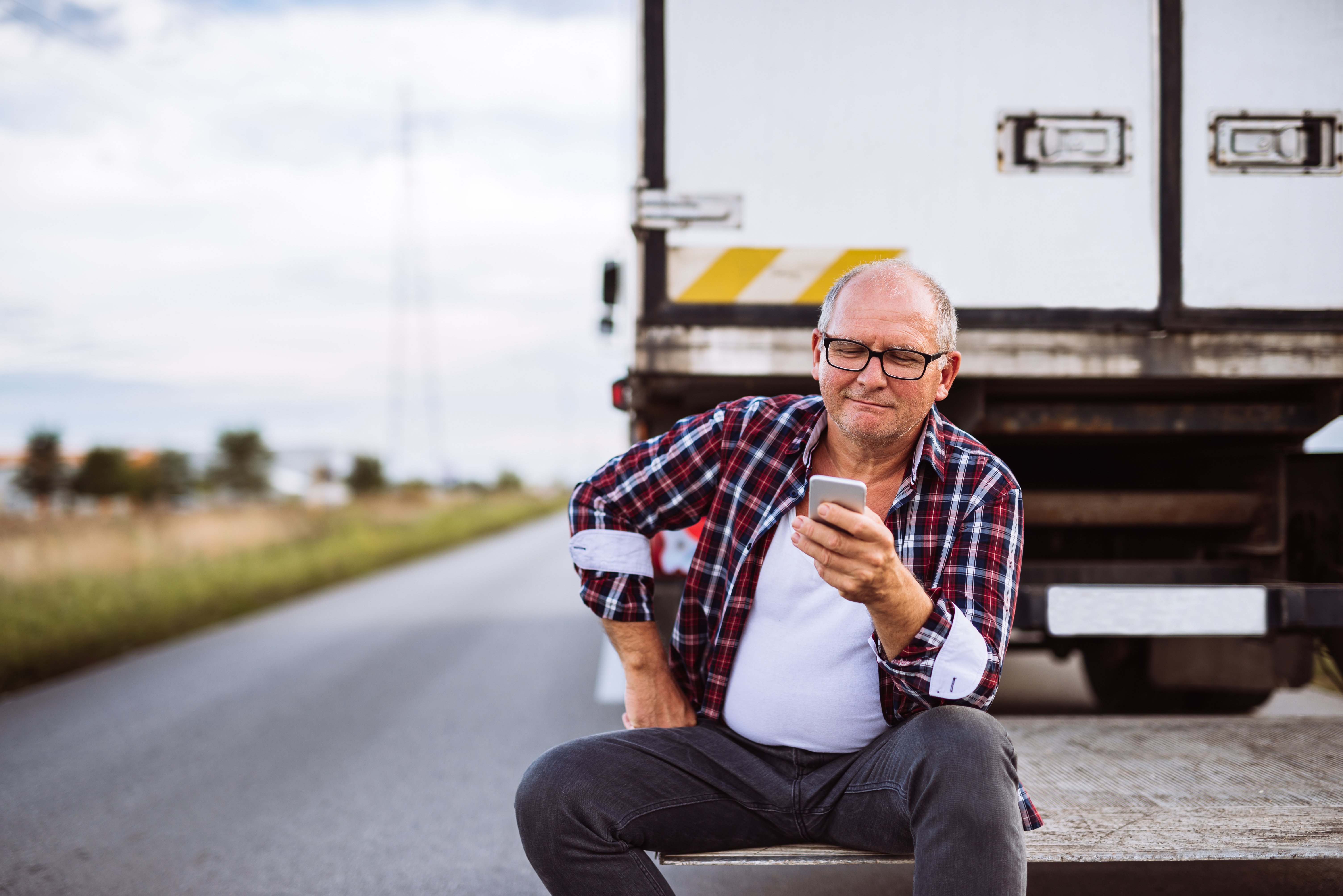 Senior man walking in front of his truck