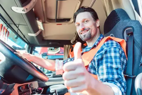 A truck driver giving a thumbs up