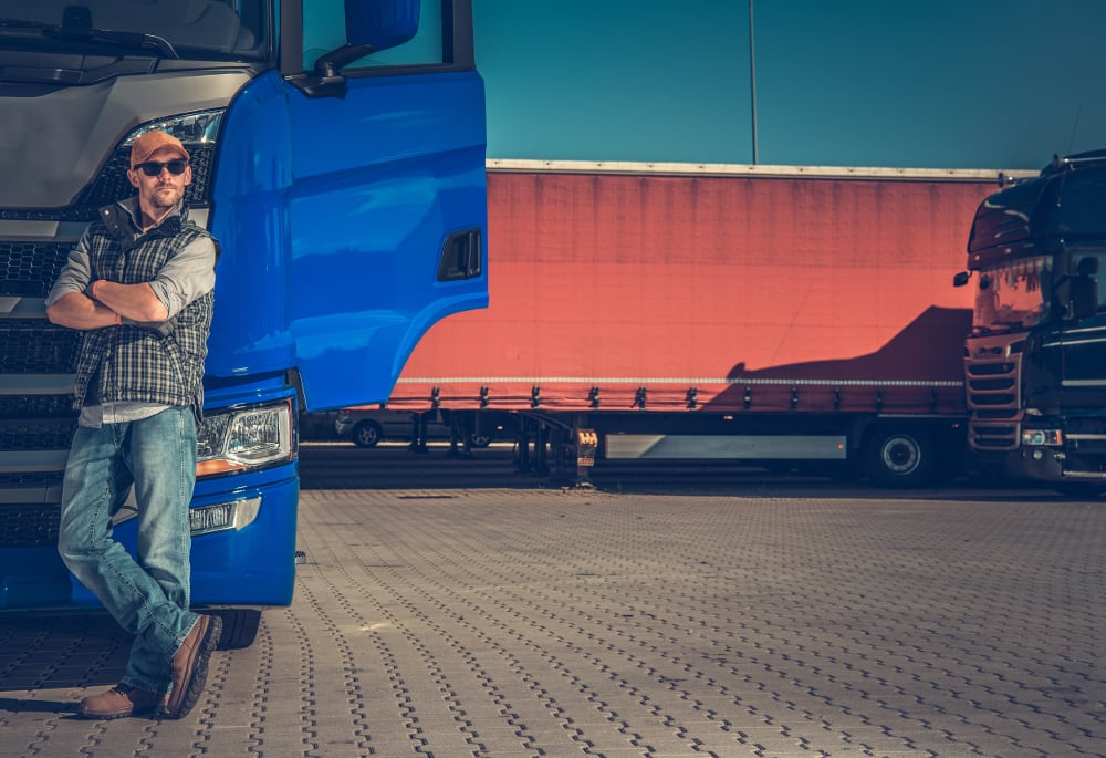 driver leaning on truck